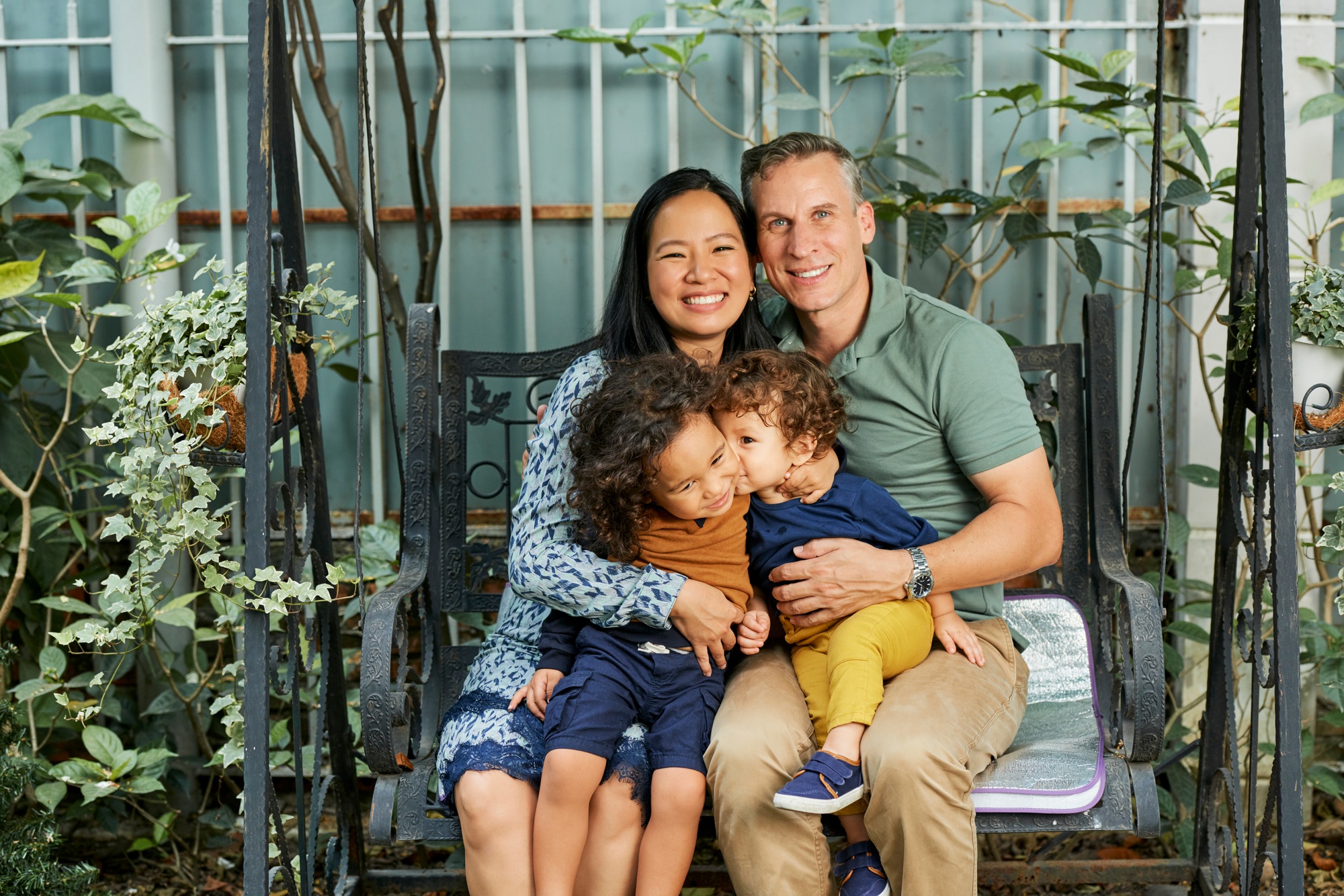 Happy Family Sitting on Swings