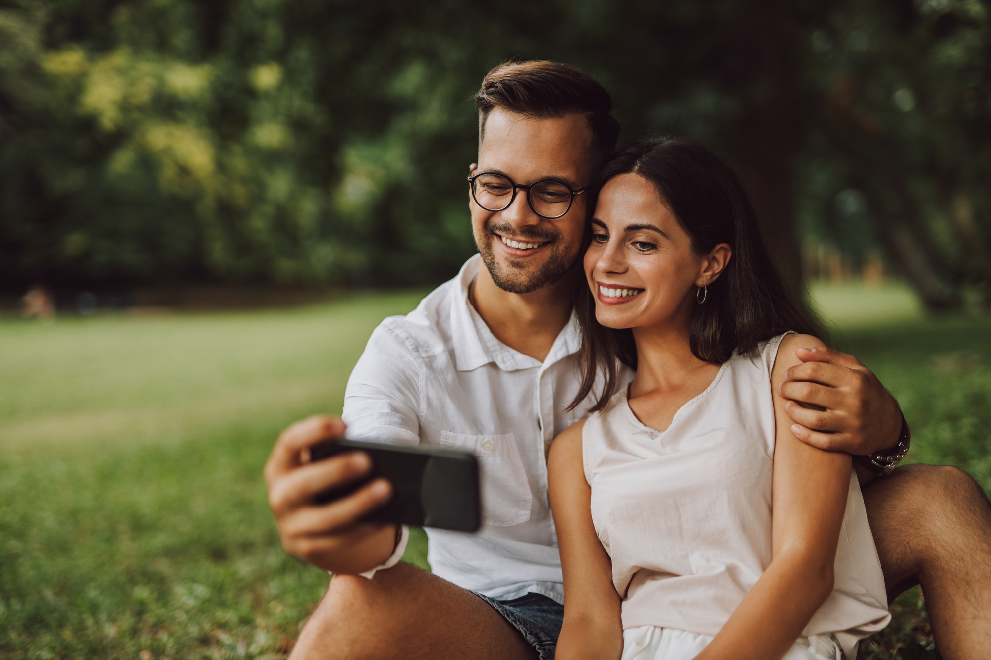 Two happy people taking pictures.
